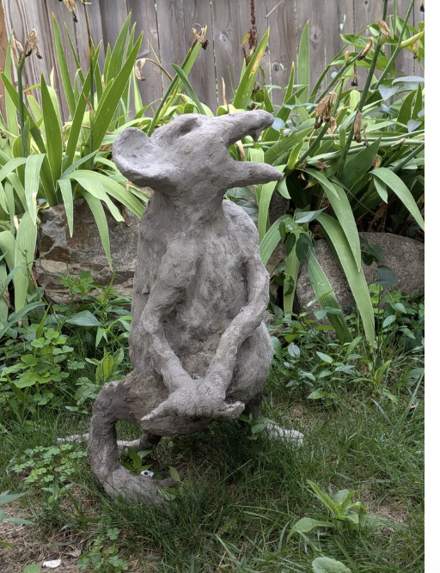 Sculpted rat with raised ears looking upward