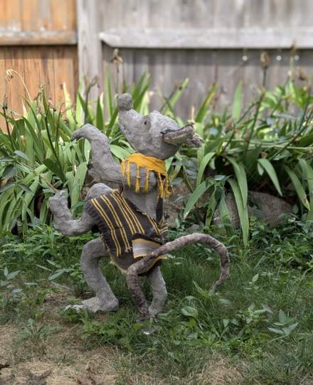 Sculpted rat in a striped yellow coat